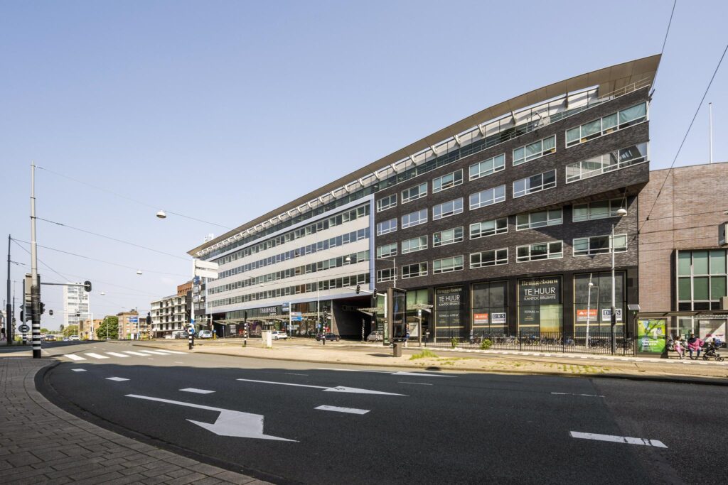 Modern office building with rental signs at Bos en Lommerplein in Amsterdam.